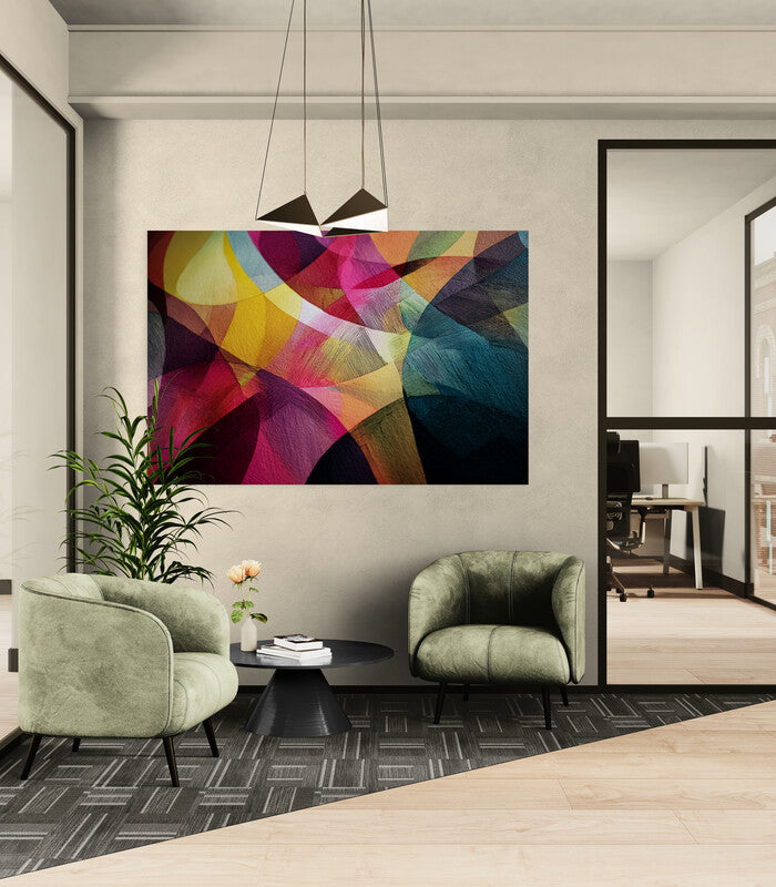 Abstract Colorful Art op een tafel, omgeven door boeken en een groene stoel, benadrukt moderne interieurstijl in een ruimte, passend bij Furndaily's veelzijdige meubelaanbod.