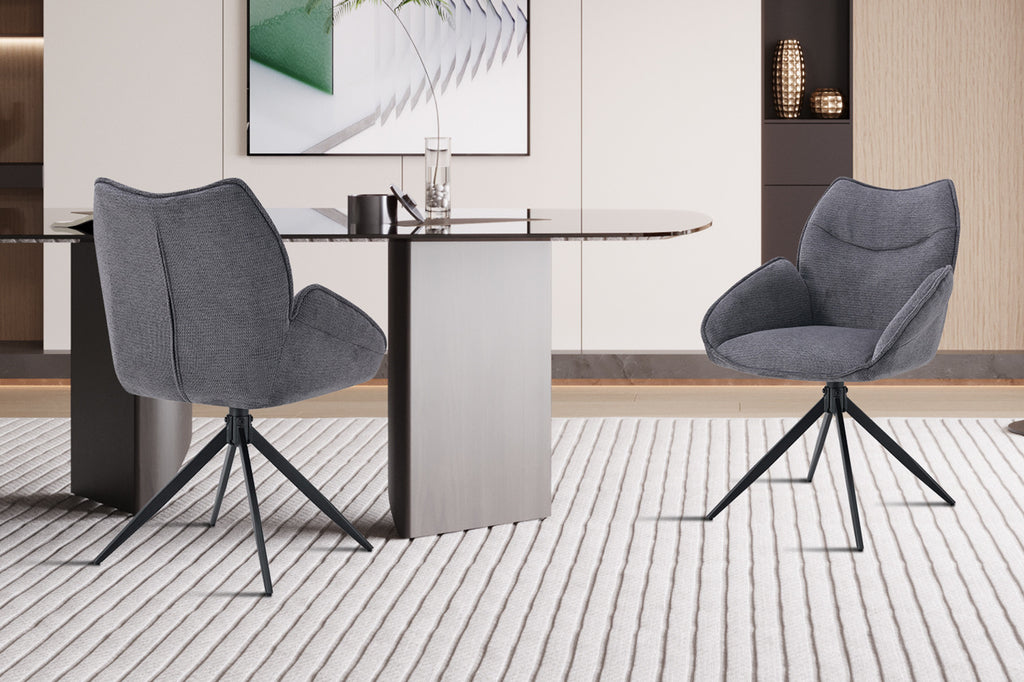 Stoel 'Mahi' Draaibaar tot 0 Stof Ote Share 456 Donkergrijs, met metalen poten en stoffen bekleding, geplaatst naast een tafel in een moderne kamer.