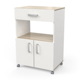 Aemely Keukentrolley Anis, een witte keukentrolley met houten accenten, zilveren handgrepen, een grote lade, open nis en verrijdbare wielen voor eenvoudige verplaatsing.
