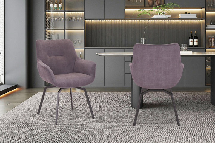 Twee draaibare 'Modest' stoelen met ribfluwelen bekleding en metalen poten, geplaatst op een kleed in een stijlvolle kamer.