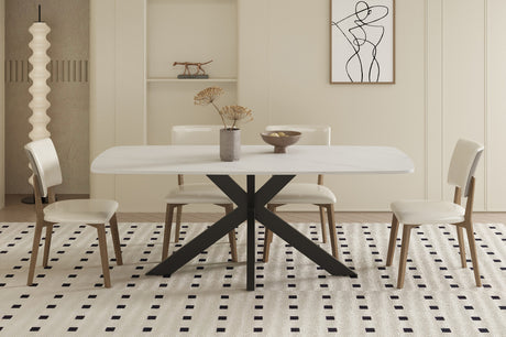Tafel 'Apollo' 180 cm met Deens ovaal stenen blad en metalen structuur, vergezeld door witte stoelen met houten poten en een vaas met droogbloemen erop.