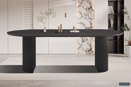 Tafel 'Lagos' 220 cm ovaal decor donkerbruin, een zwarte tafel met een plant erop, gemaakt van MDF met 3D papier, geschikt voor binnenruimtes.